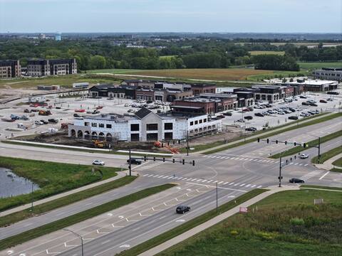 Kettlestone Social under construction seen from the northwest, with the signalised intersection at Grand Prairie Parkway in the foreground