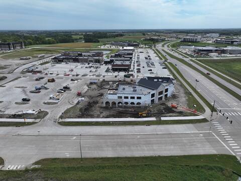 Wide aerial view over Grand Prairie Parkway in Waukee, looking along the corridor past Kettlestone Social