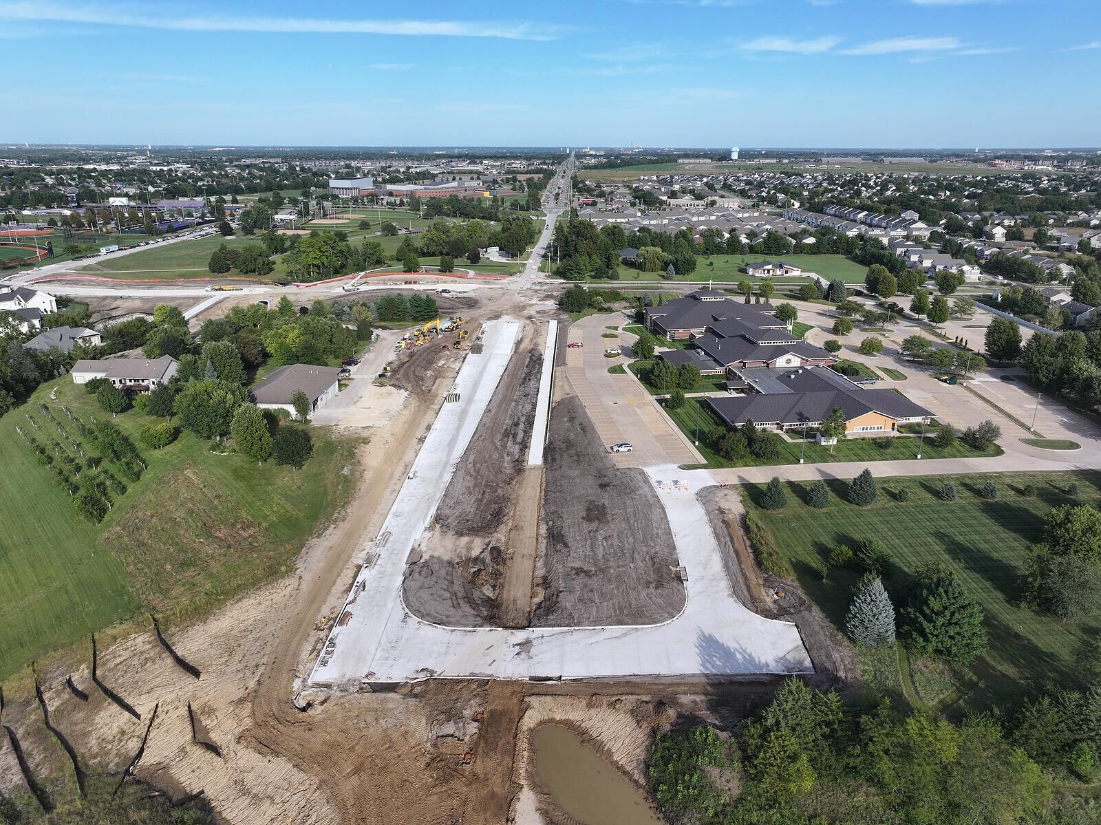 Aerial view of the University Avenue Extension corridor under construction in Waukee, Iowa, looking west toward downtown