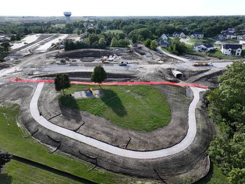 Neighborhood park beside the corridor with precast box culvert sections staged
