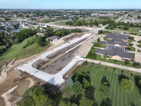 Fresh pavement and subgrade on the University Avenue Extension, looking west toward downtown Waukee