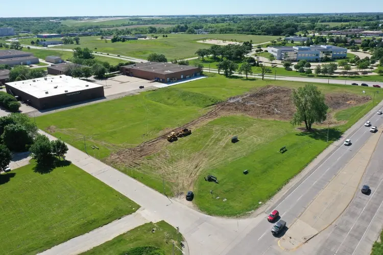 The Paws & Pints site on 29 May 2021 — an open grass field beside Willowmere Drive with the first strip of topsoil removed