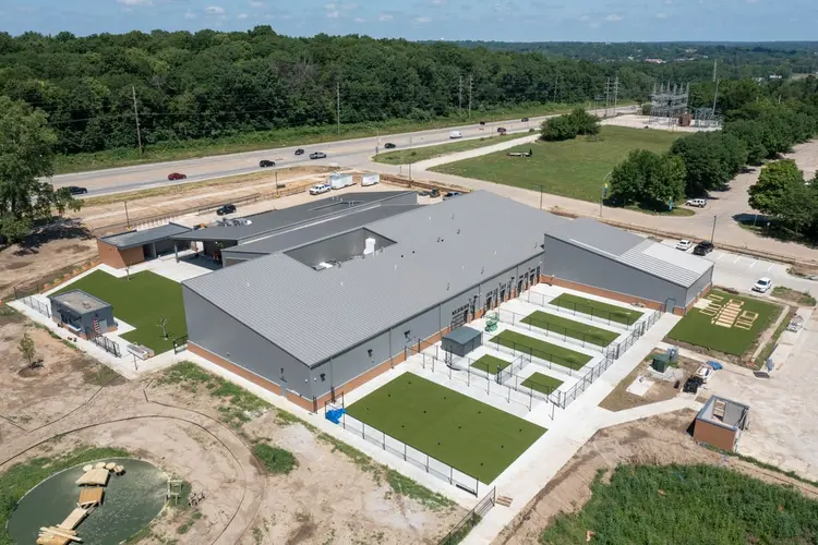 10 July 2022 — the building complete with artificial turf runs installed, the outdoor park still bare earth being shaped