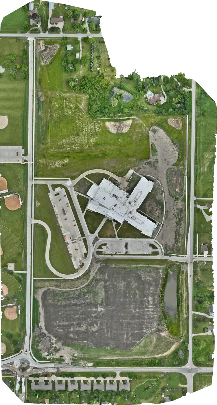 Aerial site map of the completed Southeast Polk Middle School, 22 June 2024 — laydown gone, construction traffic clear, grass in to the property line